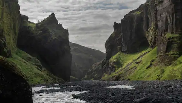 A river is serpenting all the way to the entrance of a wide canyon